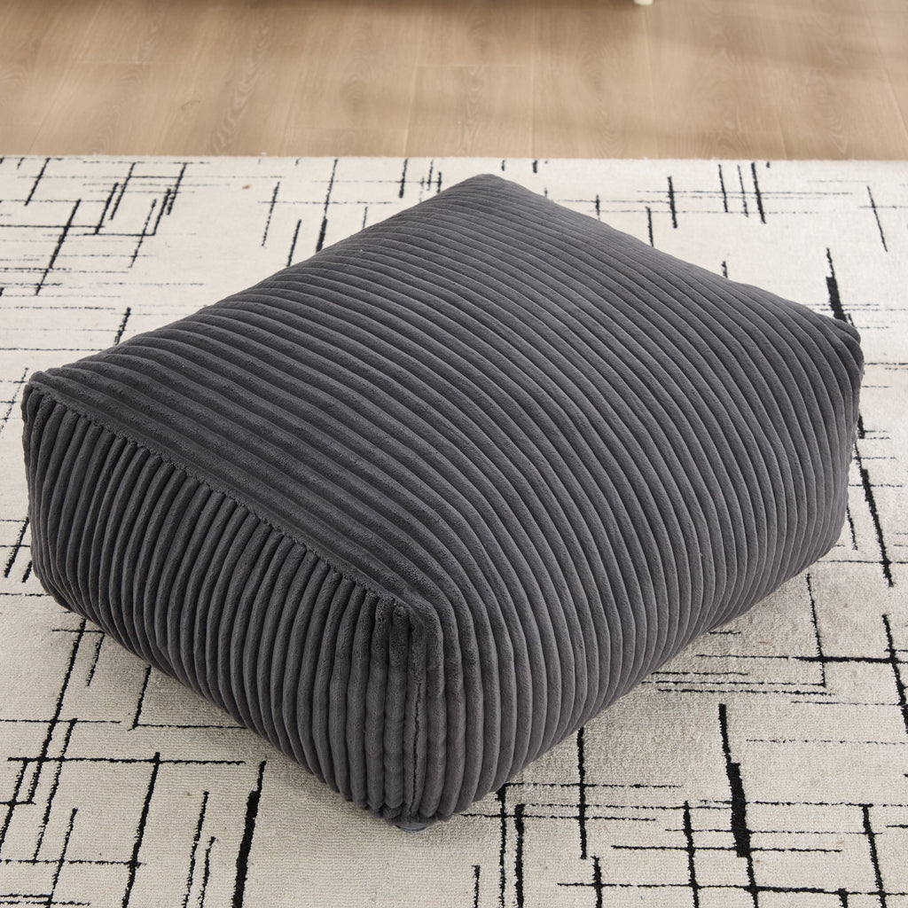 Close-up of the corduroy ottoman showing its wide-wale ribbed texture