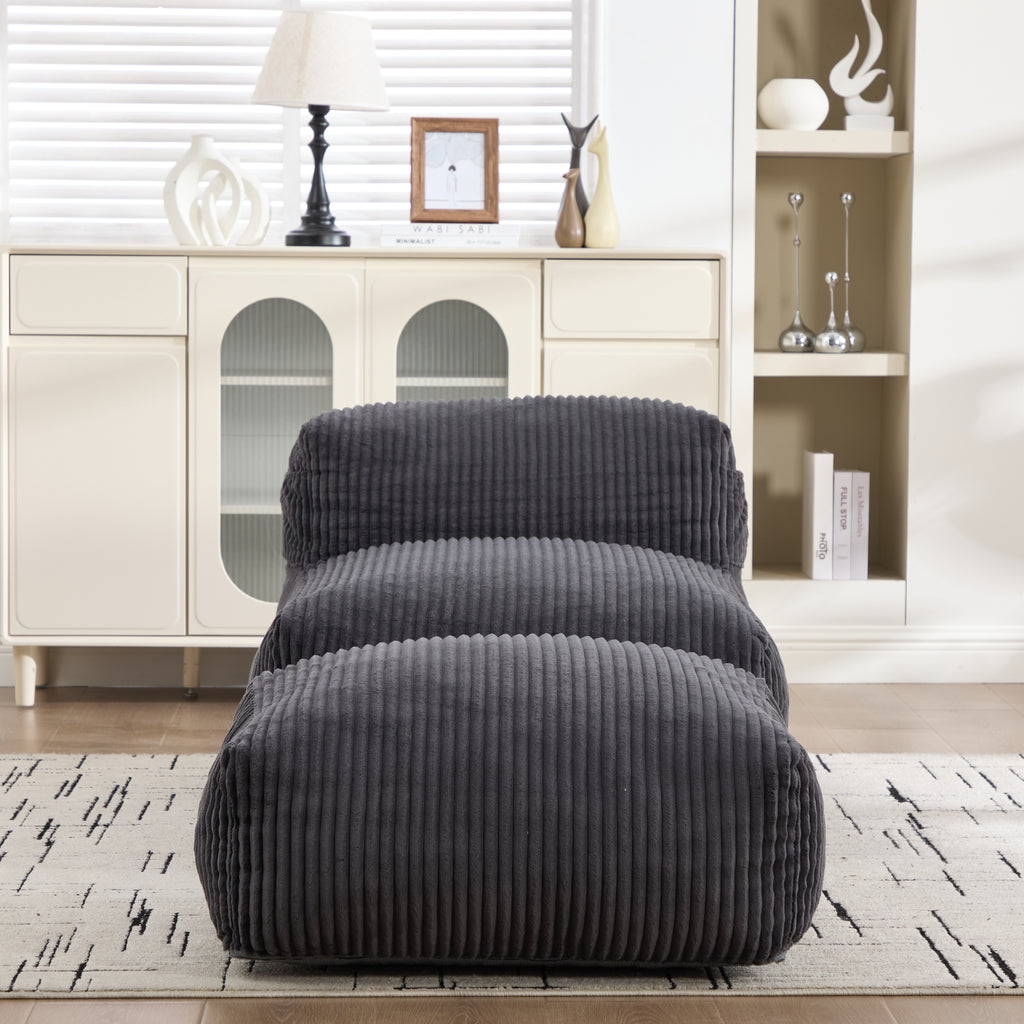 Corduroy bean bag chair and ottoman set against a white shelving unit