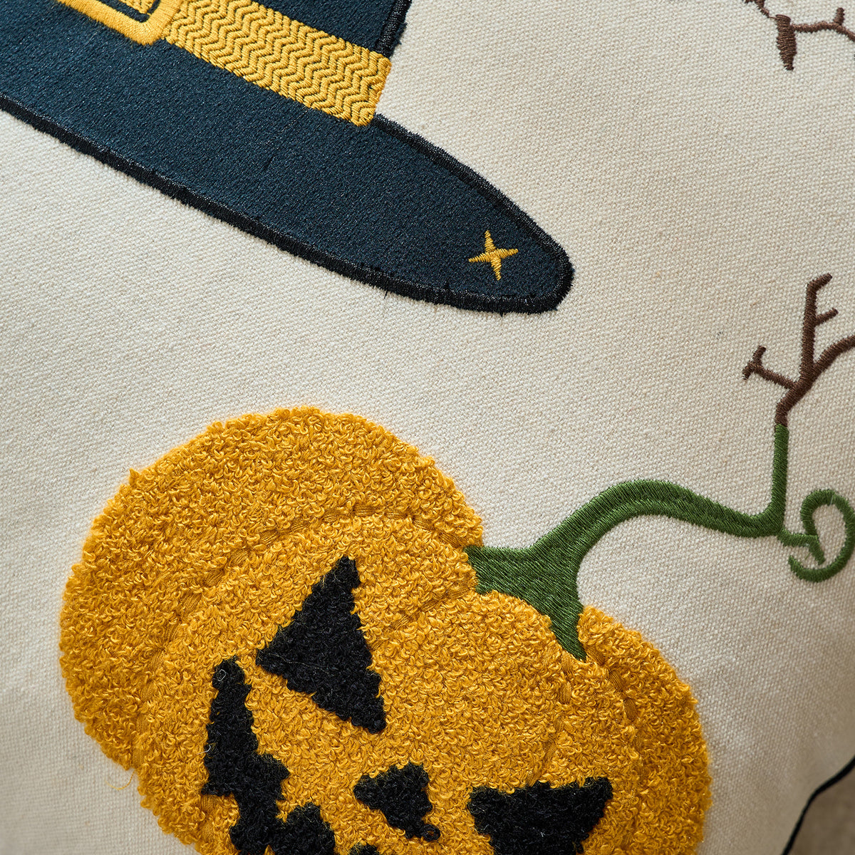 Close-up of the orange pumpkin and witch hat tufted embroidery detail