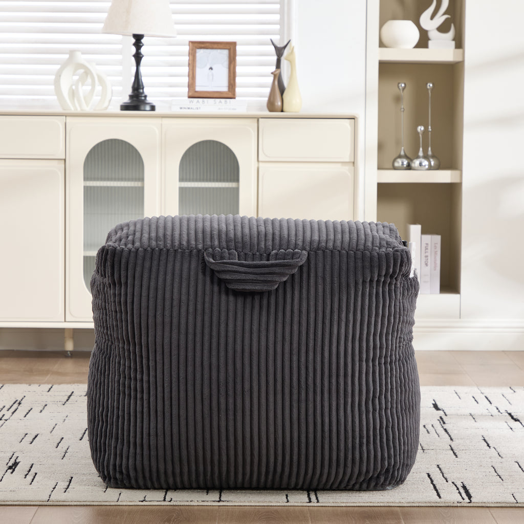 Dark gray bean bag chair styled in a bright living room corner