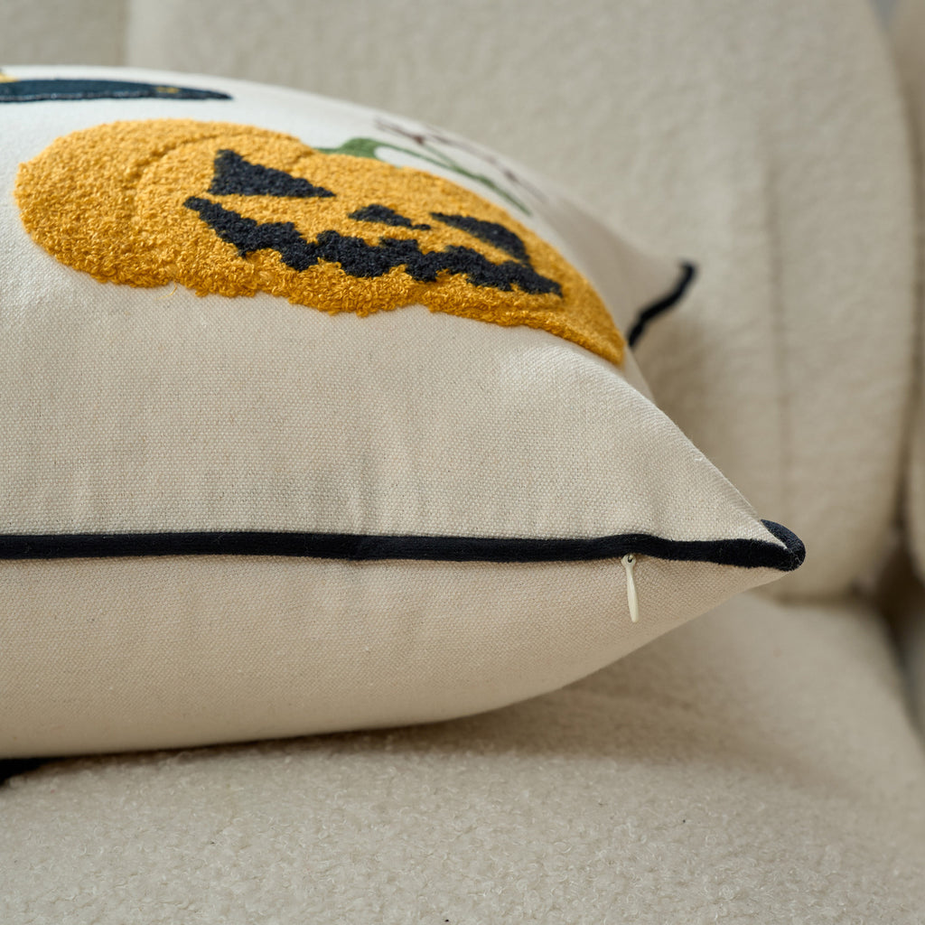 Close-up of the pumpkin motif beside the contrast black piped edge