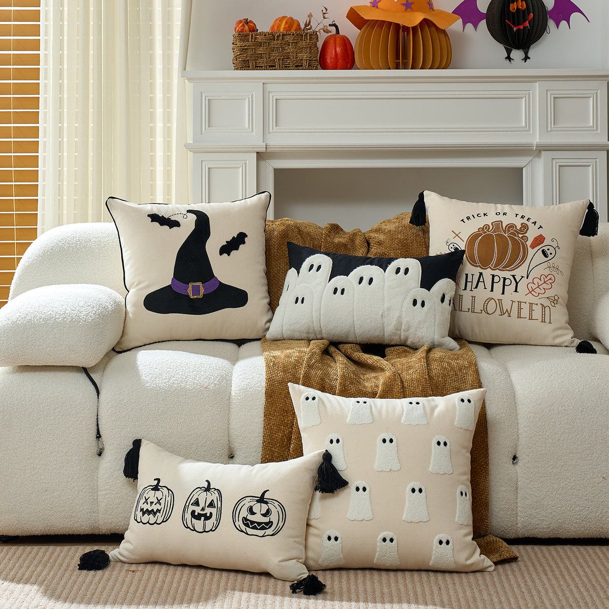 Halloween tufted cushion covers arranged across a cream sofa with rust throw