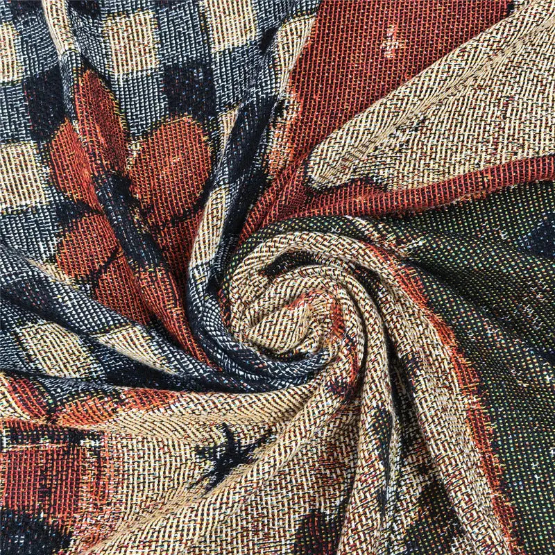 Rolled Halloween blanket showing its woven reverse and fringed edge