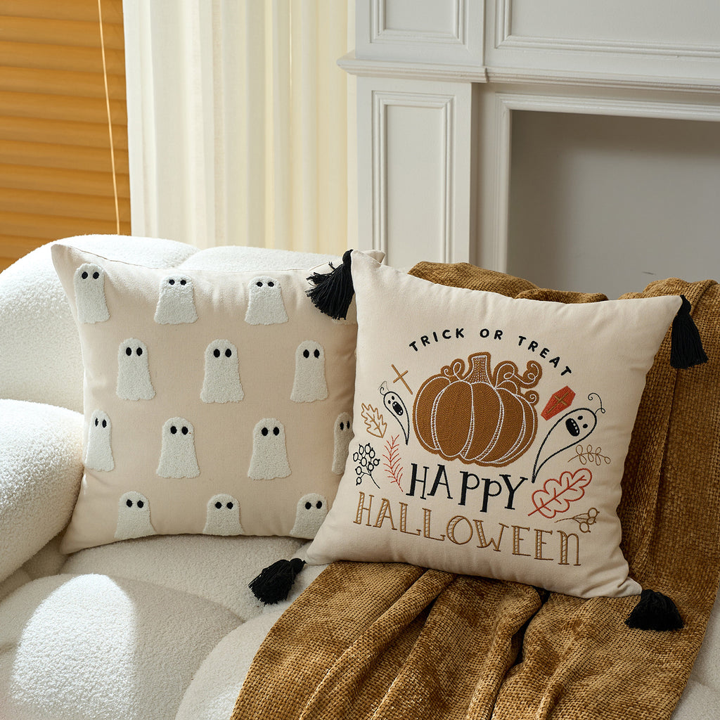 Happy Halloween pumpkin cushion cover on a cream sofa with warm throw