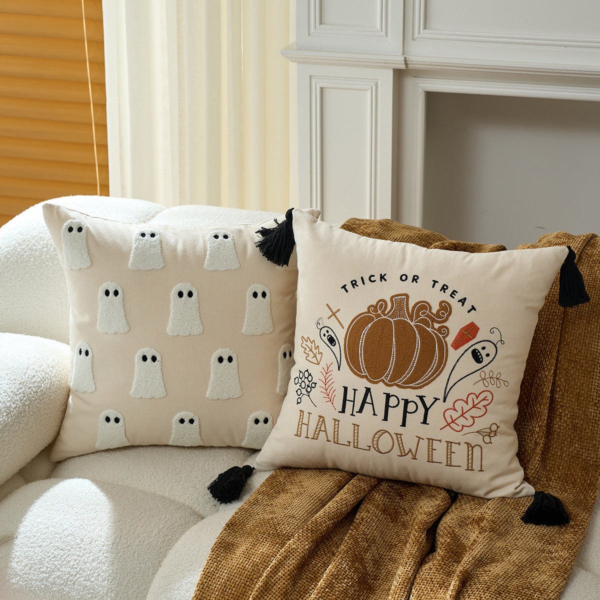 Happy Halloween pumpkin cushion cover on a cream sofa with warm throw