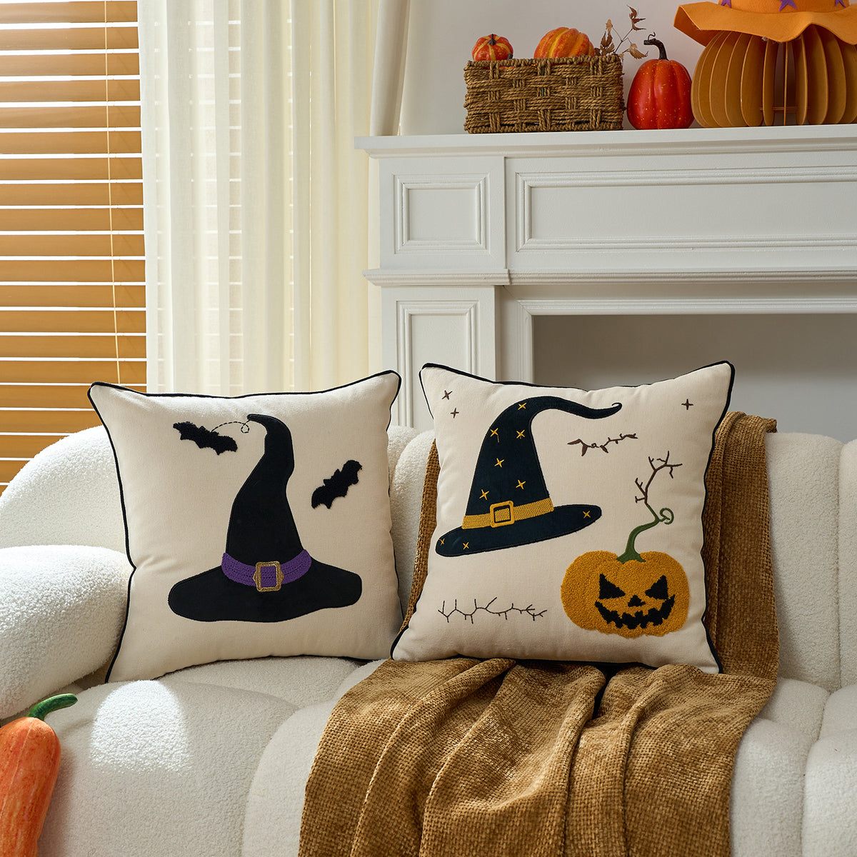 Witch hat and pumpkin face cushion covers paired on a sofa