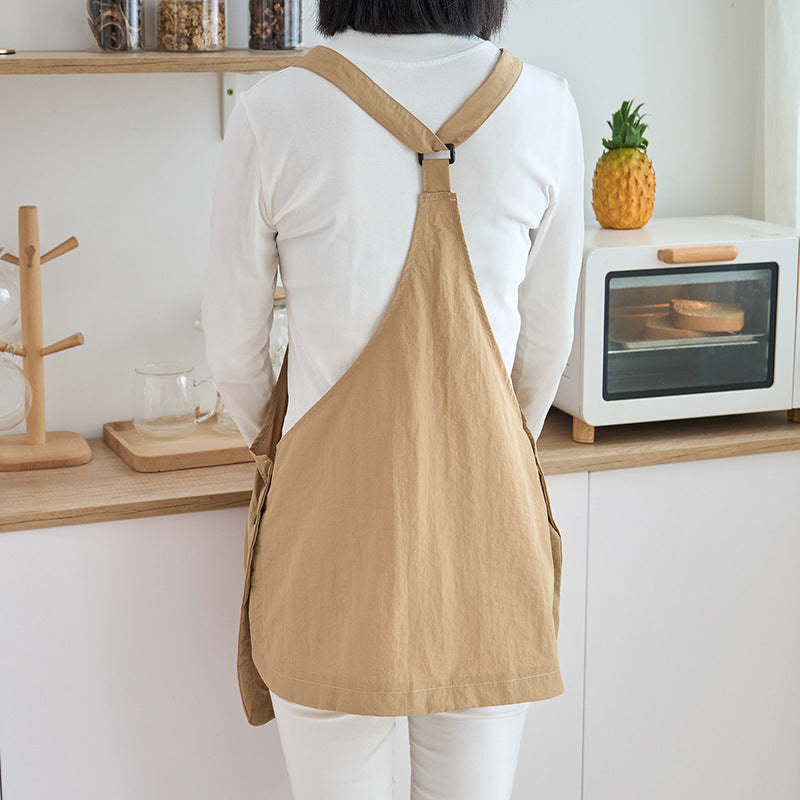 Back view of the khaki kitchen apron showing the crossed straps