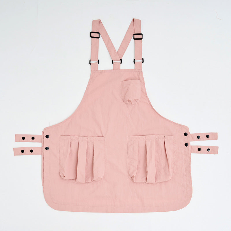 Soft pink sleeveless kitchen apron with twin front pockets