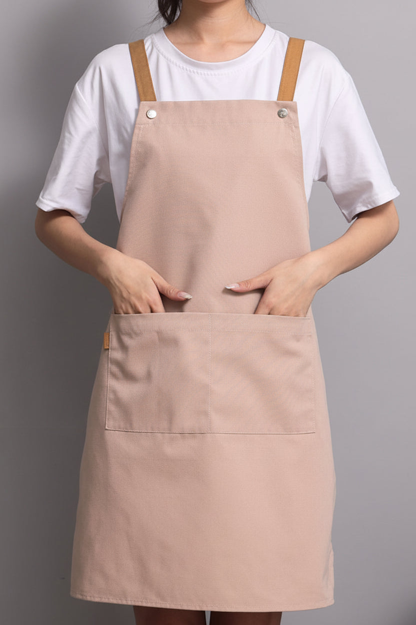 Woman wearing a light coffee canvas apron with adjustable neck strap