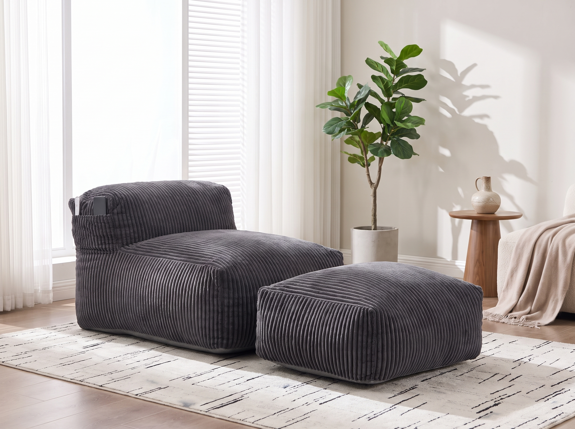 Corduroy bean bag lounger with the matching ottoman positioned in front of a large window with daylight