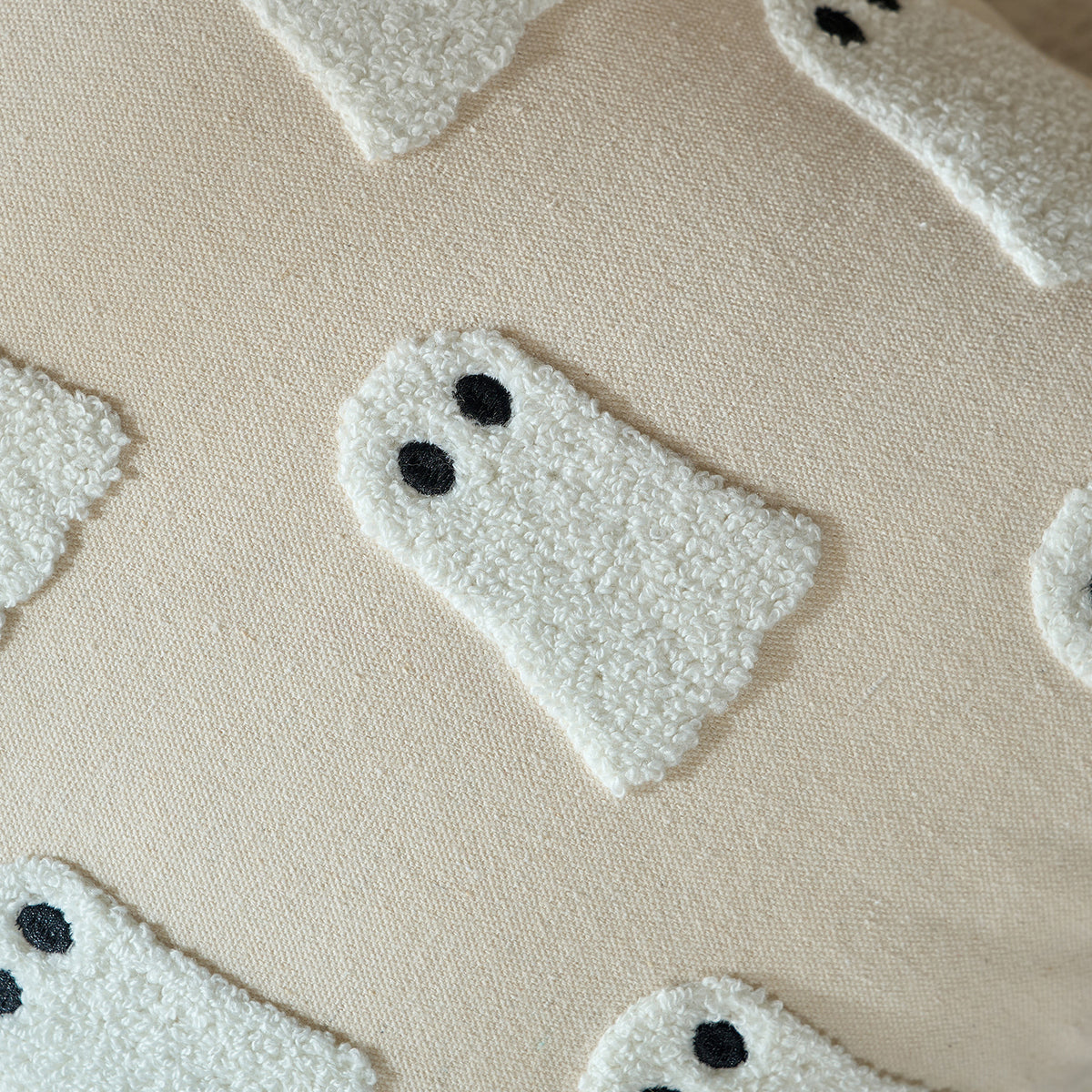 Close-up of the tufted mini ghost print texture on cream fabric