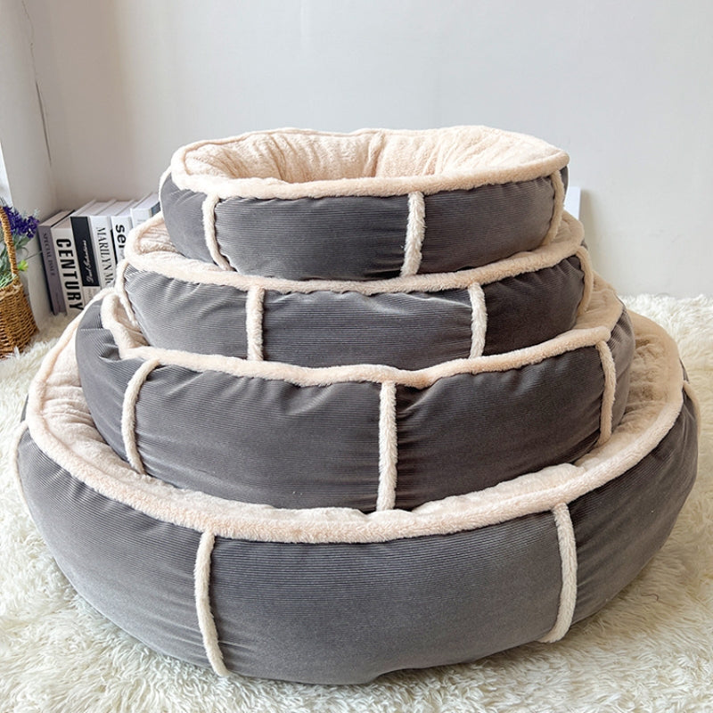 Three sizes of the grey round pet bed stacked to compare