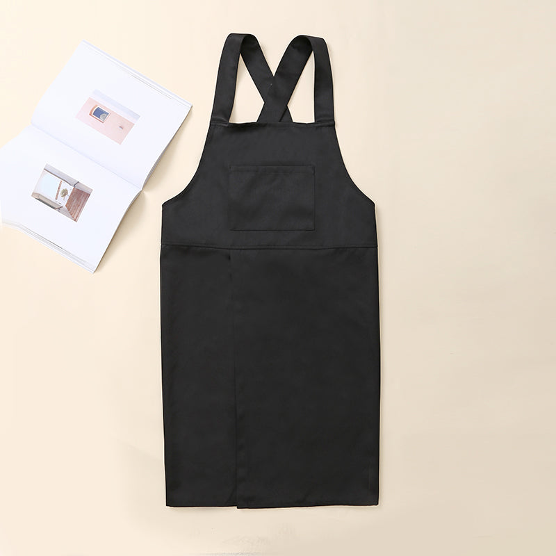 Black Korean style kitchen apron with cross-back straps shown flat