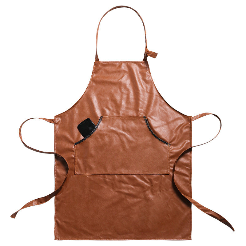 Tan leather work apron laid flat with adjustable neck and waist straps