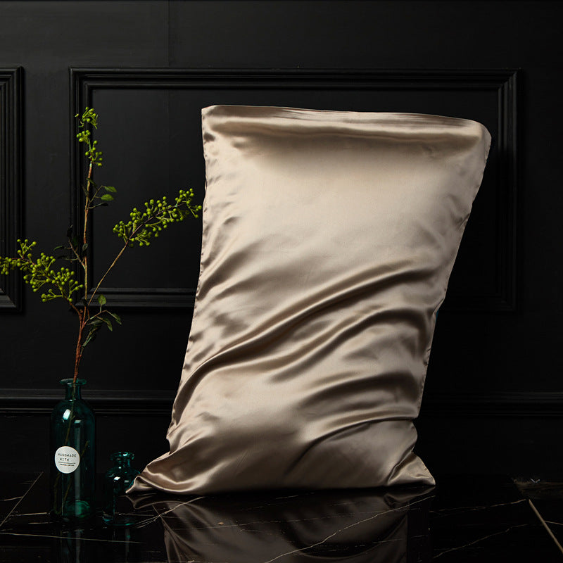 Gentleman coffee brown mulberry silk pillowcase styled beside a slim glass vase