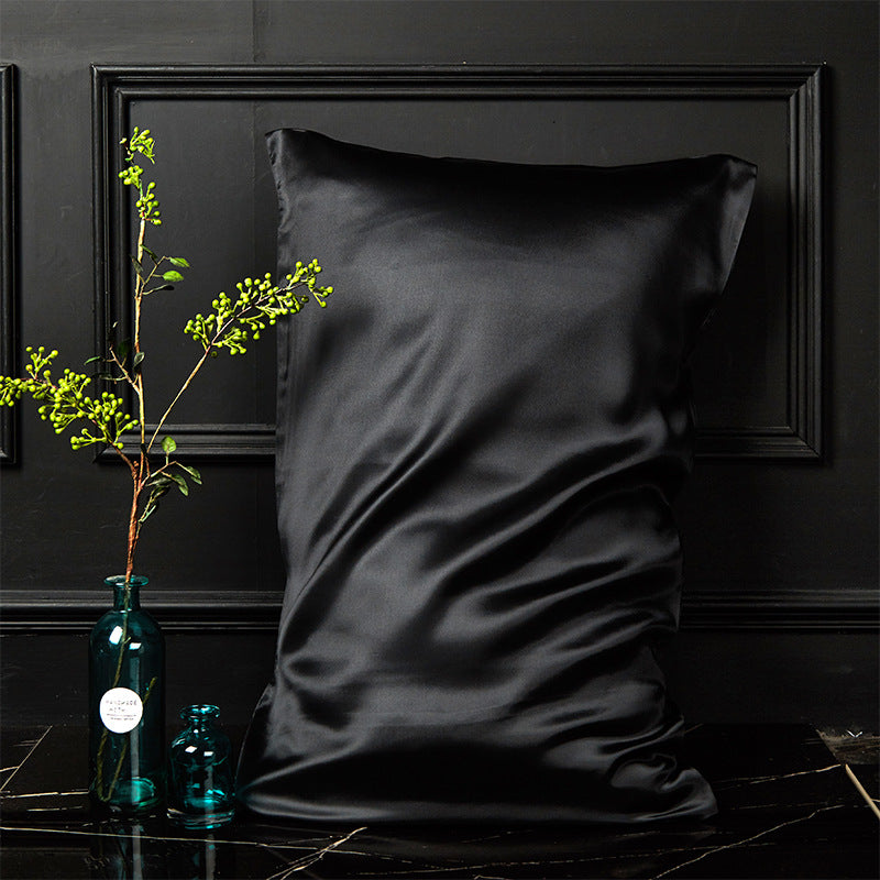 King black mulberry silk envelope pillowcase against a dark panelled bedroom wall
