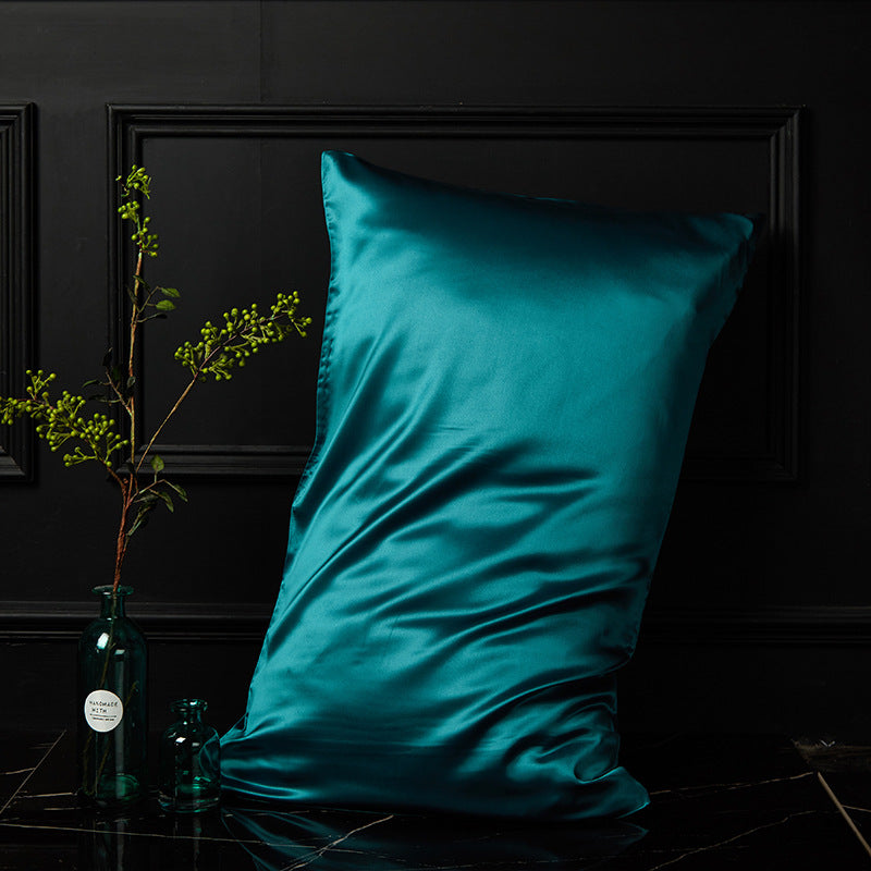 Teal peacock blue silk pillowcase showing envelope closure detail and silk drape