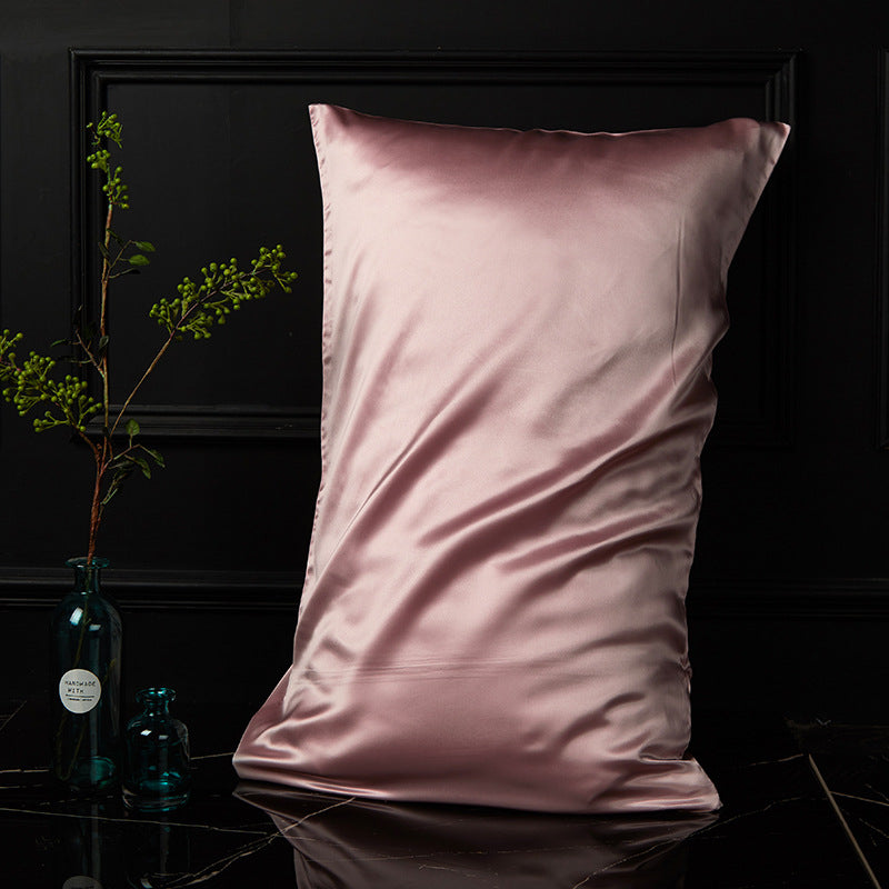 Rose pink mulberry silk envelope pillowcase with soft drape on black marble